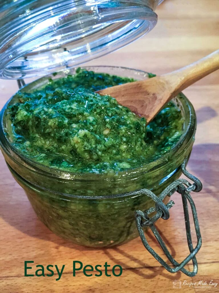 jar of pesto with wooden spoon.