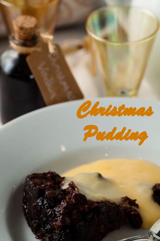 Serving of Christmas pudding with custard.