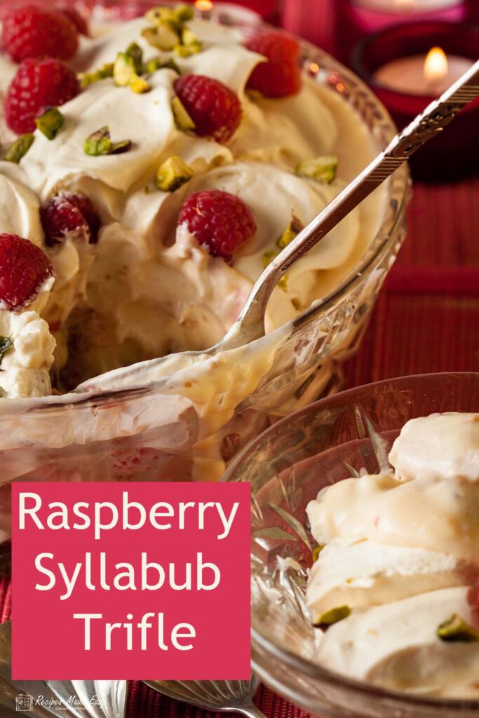 raspberry syllabub trifle with portion removed and in glass dish.