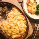 shepherds pie with portion removed and on a plate next to it