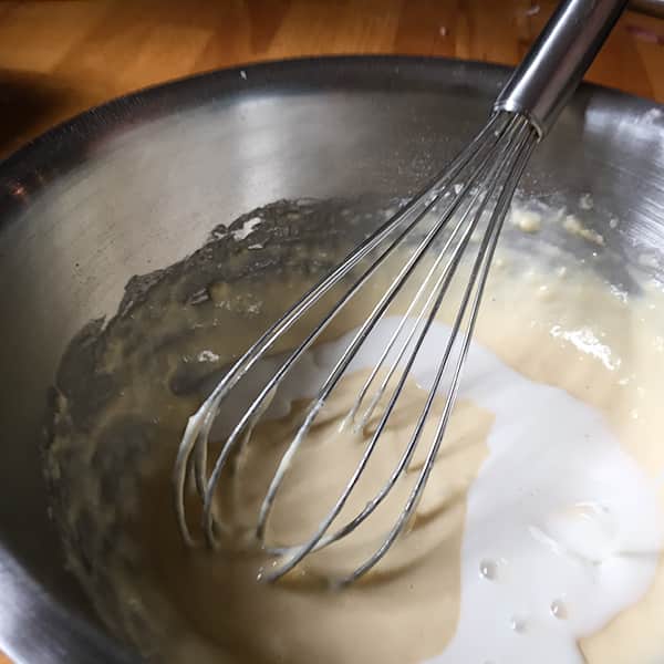 milk added to batter in bowl.