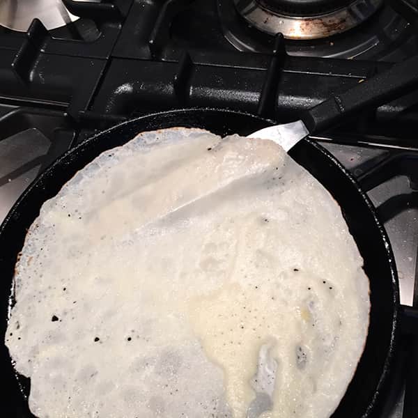 using a plaette knife to flip the pancake over