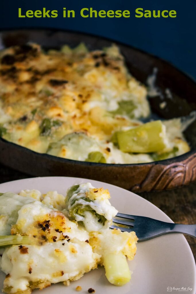 serving of cheese in leek sauce on plate with fork.