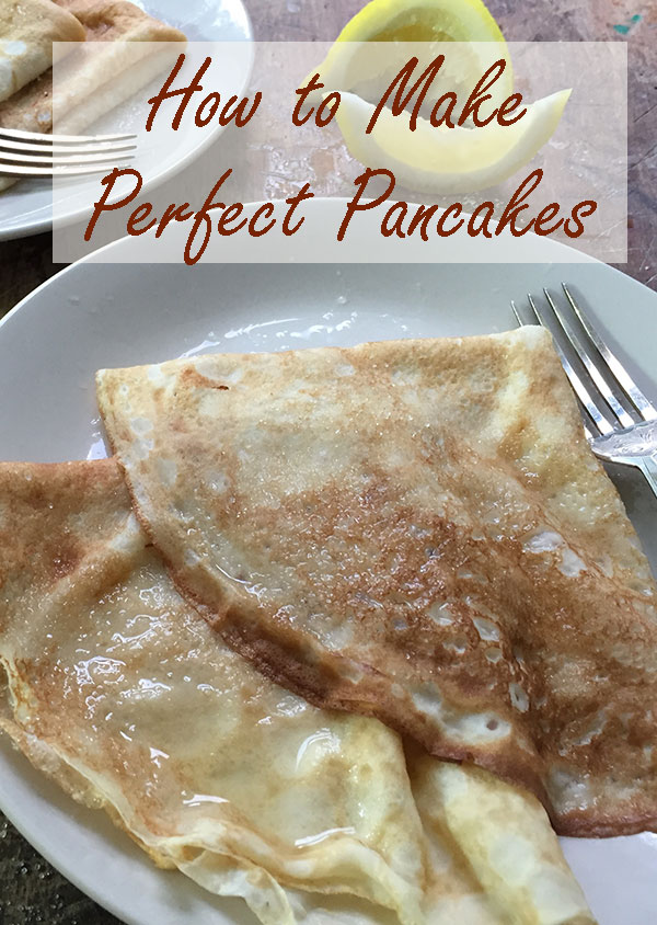 two pancakes on a plate with a fork