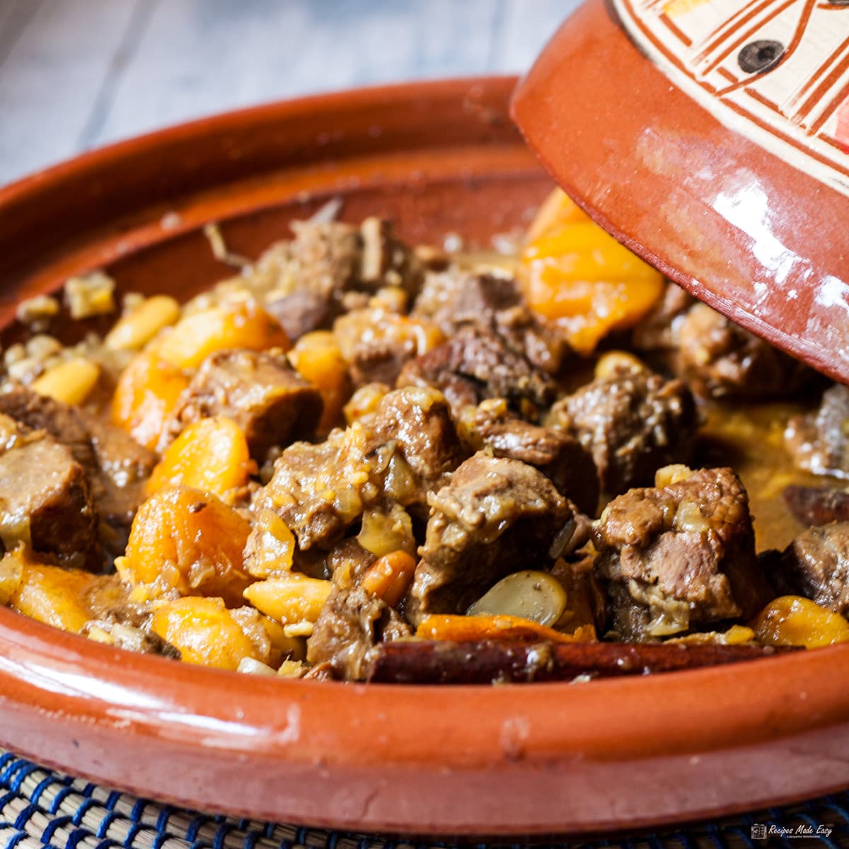 Easy Lamb tagine in traditional dish with lid part covering.