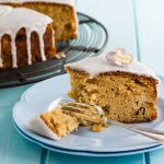 Rhubarb cake with elderflower drizzle icing with slice on plate