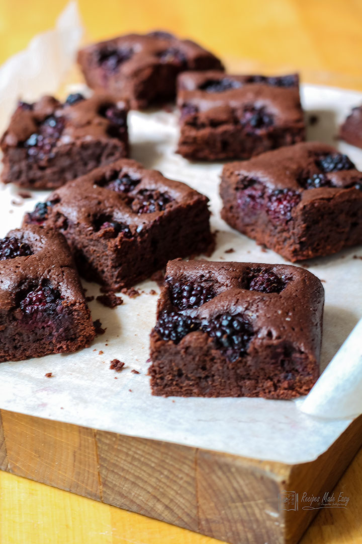 blackberry brownies on a board