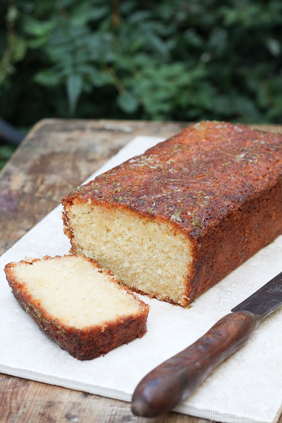 Coconut and lime drizzle cake with a slice laying down
