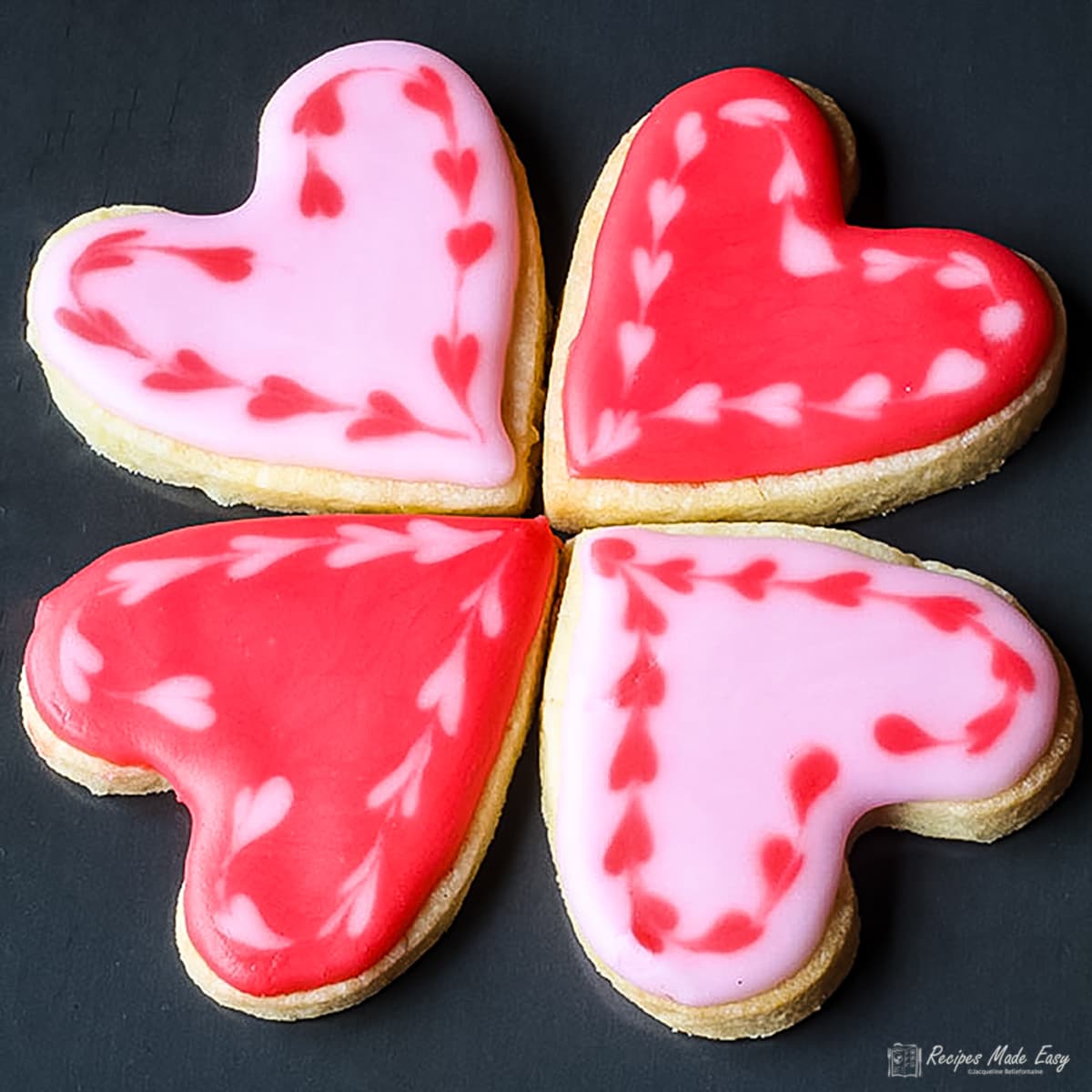 4 sweetheart cookies on a tray.