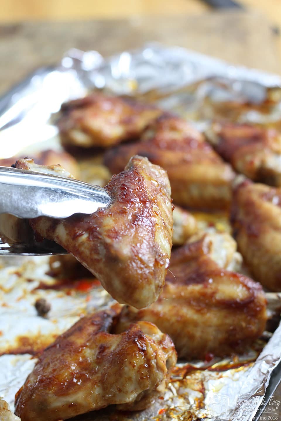hot and spicy chicken wings on a baking sheet