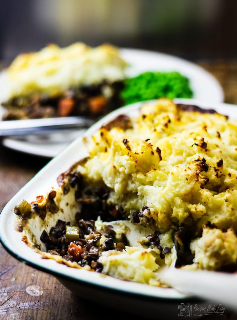 vegetvale and lentil bake with serving spoon in dish.