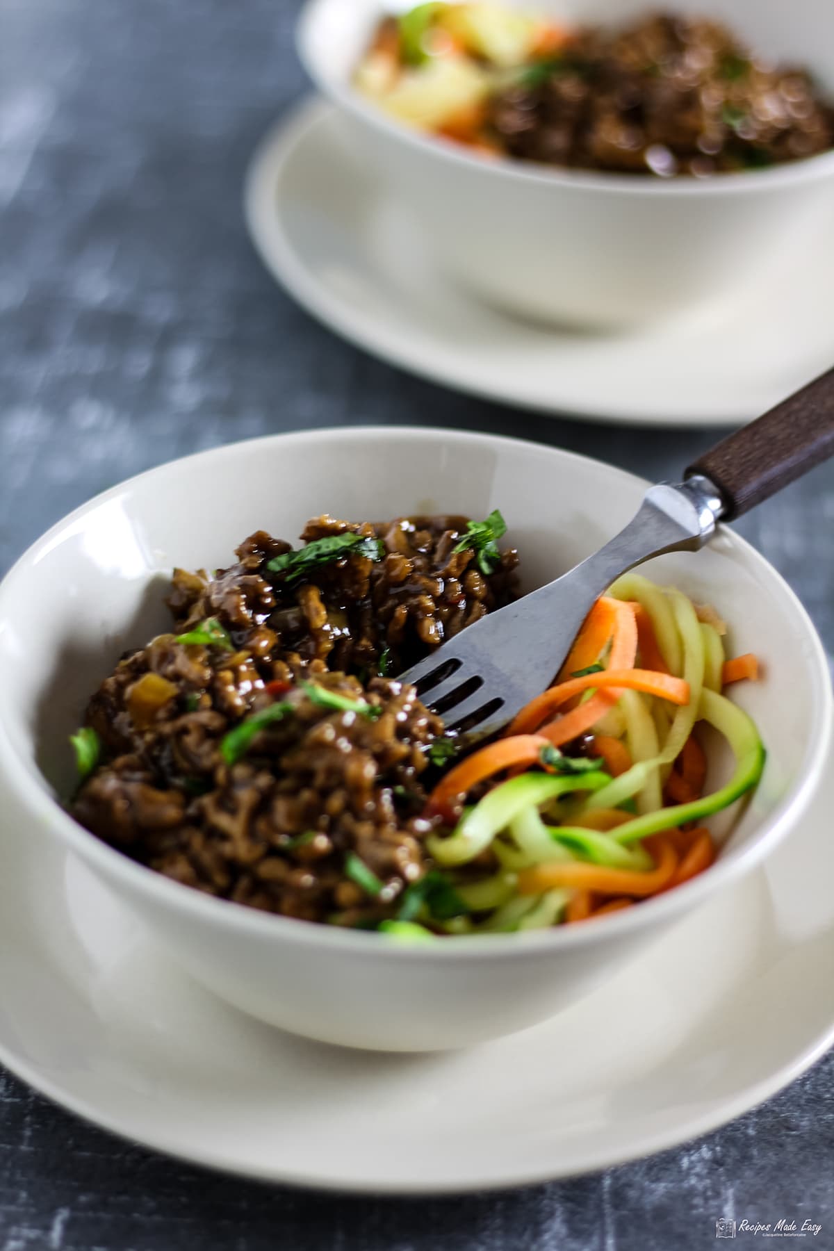 Asian inspire spicy pork mince served with spiralised vegeables in a bowl.