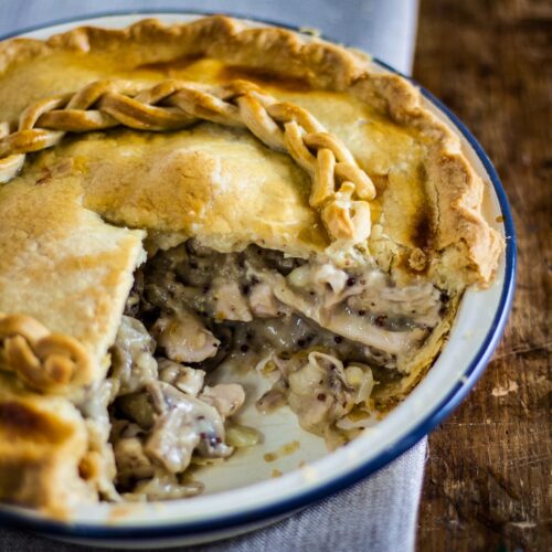 chicken and mushroom pie with portion removed showing filling.