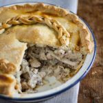 chicken and mushroom pie with portion removed.