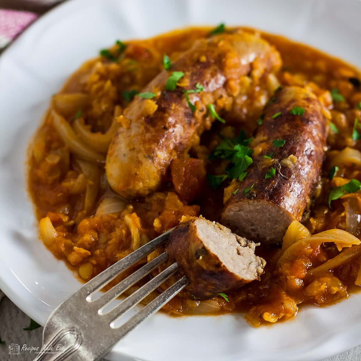 sausage and red lentil casserole with a piece of sausage on a fork.