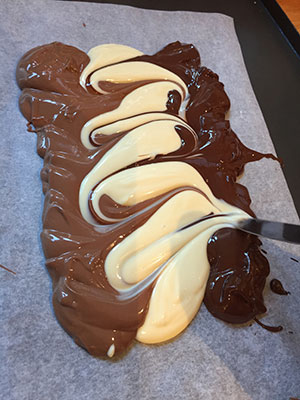 Use a dinner knife to swirl the chocolate together. Use a dinner knife to swirl the chocolate together.