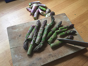 Prepare the asparagus, discard woody ends and cut into short lengths. preparing asparagus for chicken and asparagus traybake by recipes made easy