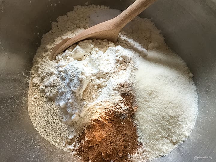 dry ingredients in bowl with wooden spoon.