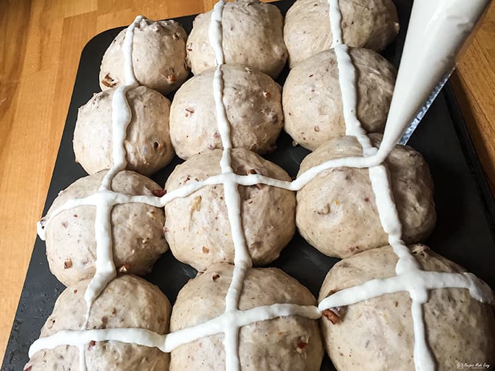 piping crosses on hot cross buns.