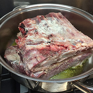 Brown on both sides. Braised beef short ribs - borwning in pan
