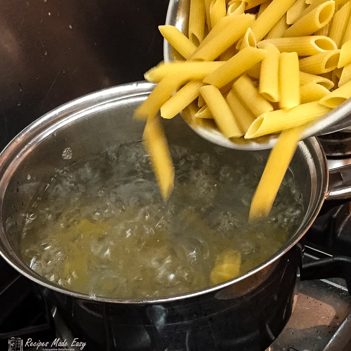 Adding pasta to boiling water.