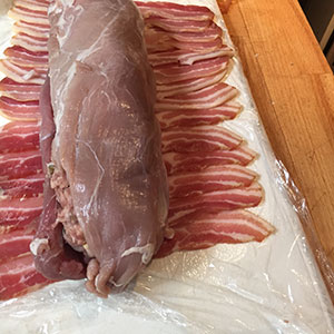 Place second tenderloin on top. two pork tenderloins on streaky bacon