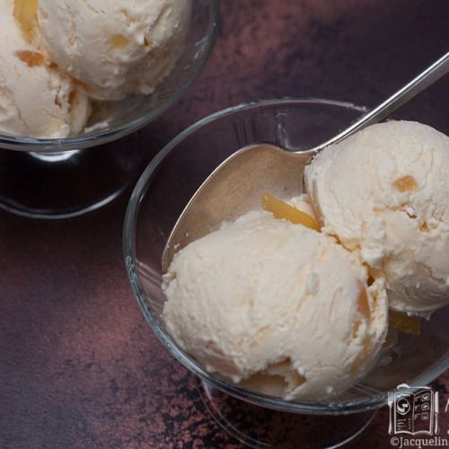 landsacpe shot of 2 scoops of ice cream in a bowl with second bowl in background.