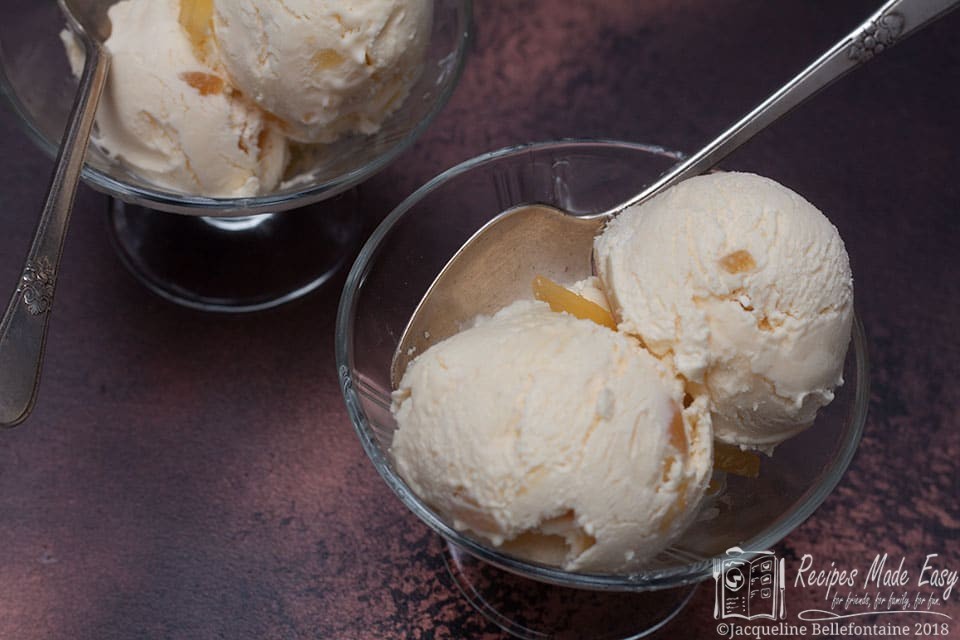 landsacpe shot of 2 scoops of ice cream in a bowl with second bowl in background.