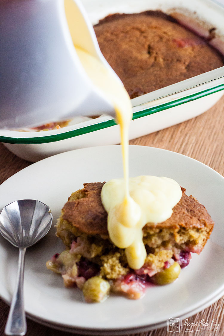 pouring custard onto portions of eves pudding.
