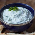 Really easy tzatziki by recipes made easy in a serving bowl with bread for dipping.