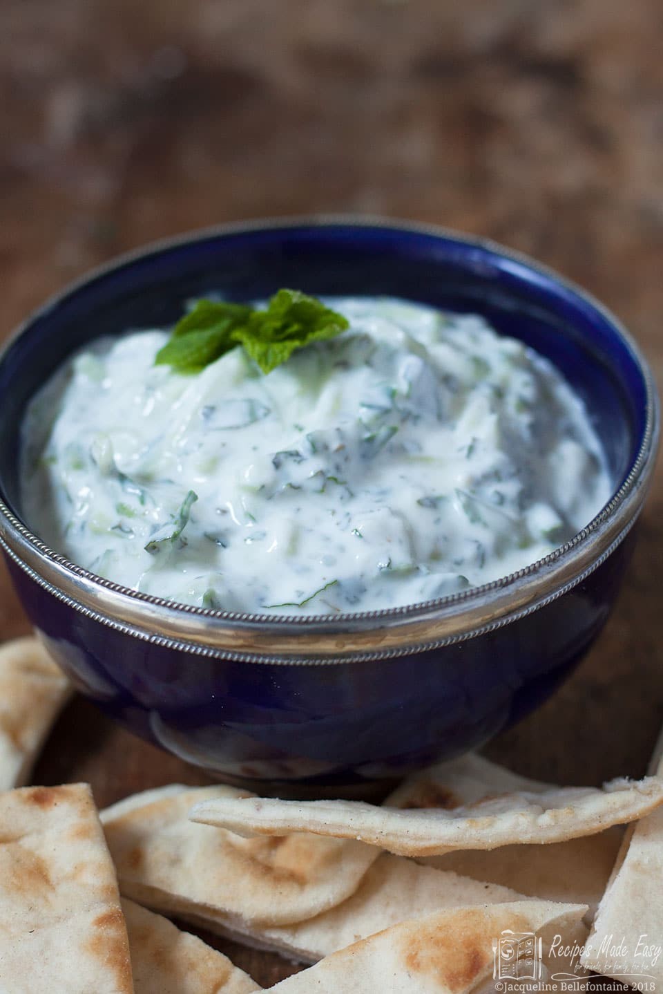 Really easy tzatziki by recipes made easy in a serving bowl with bread for dipping.