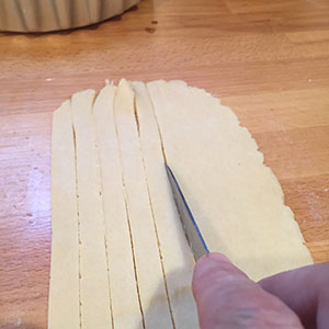 cutting strips of pastry.