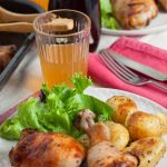 plate of malt vinegar chicken with salad and potatoes.