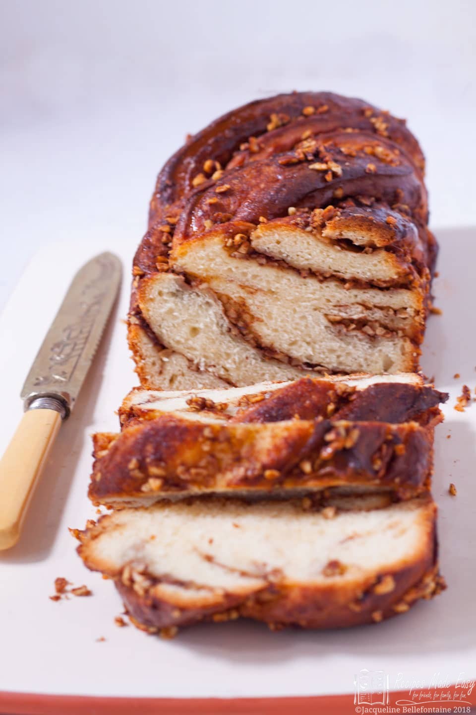 cinnamon and nut babka, sliced with knife by the side