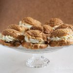 craquelin choux buns on a cake stand