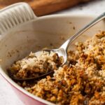 sage and onion stuffing is dish with spoon.