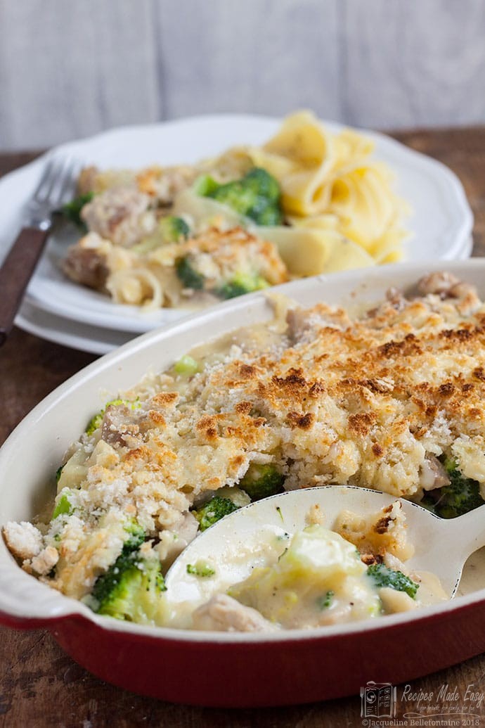 Chicken and broccoli au gratin in dish with serving spoon.