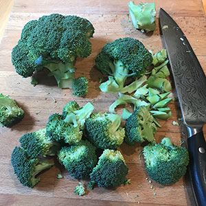 broccoli florets and knife on chopping board
