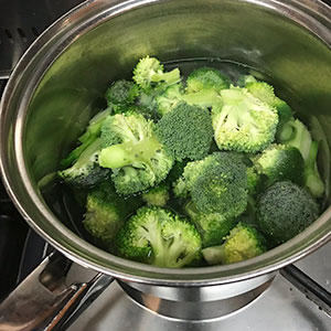 broccoli in pan of water