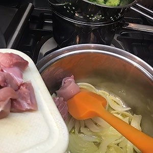 adding chicken to pan