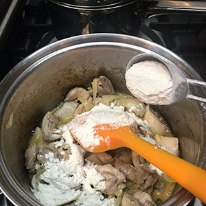 adding flour to pan