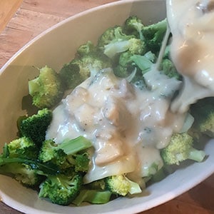 pouring sauce over broccoli