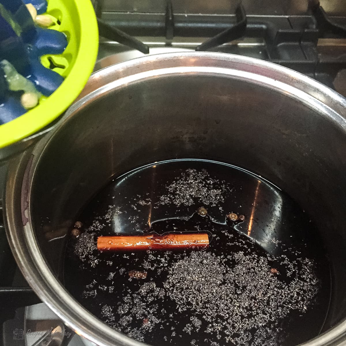 wine and spices in saucepan , adding lemon juice.