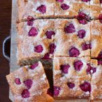 Hi fibre raspebrry yogurt cake cut into squares on a board