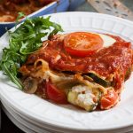 close up of serving of three cheese vegetarian lasagne on a serving plate