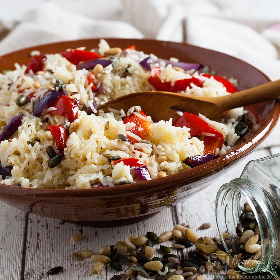 bowl of rice salad with seed spilt onto work surface in front