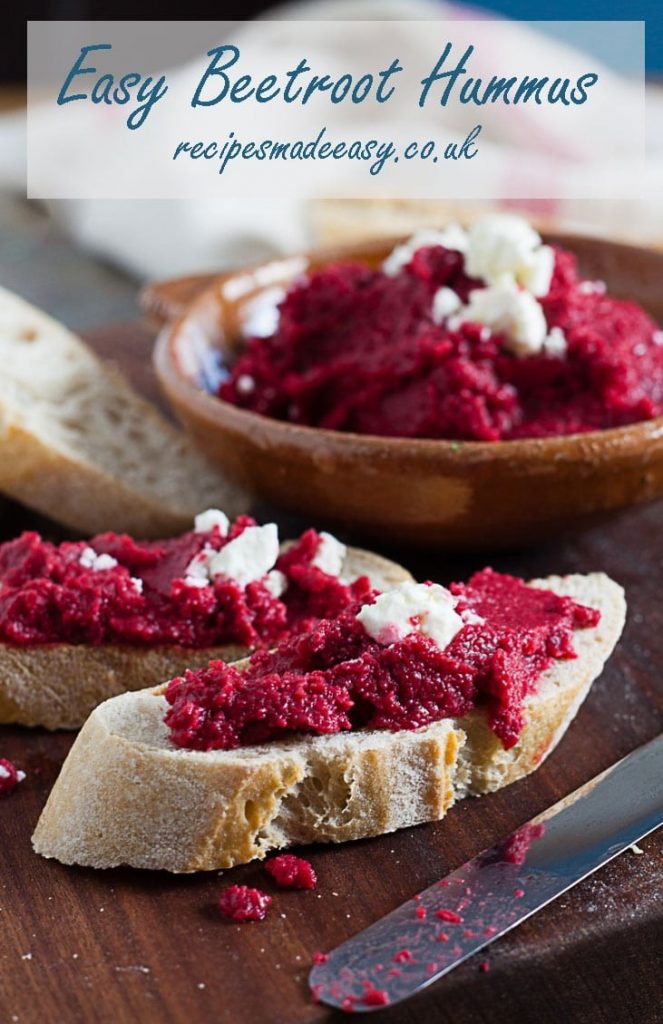 beetroot hummus spread on bread with bowl of the hummus in background