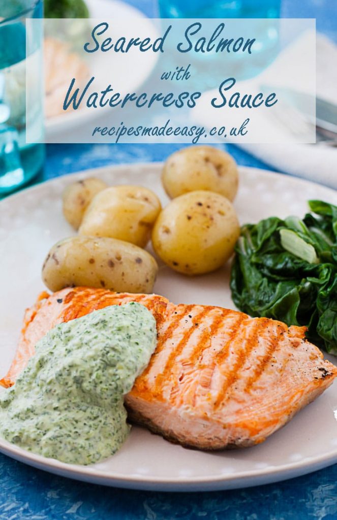 plate of seared salmon with watercress sauce, potatoes and greens