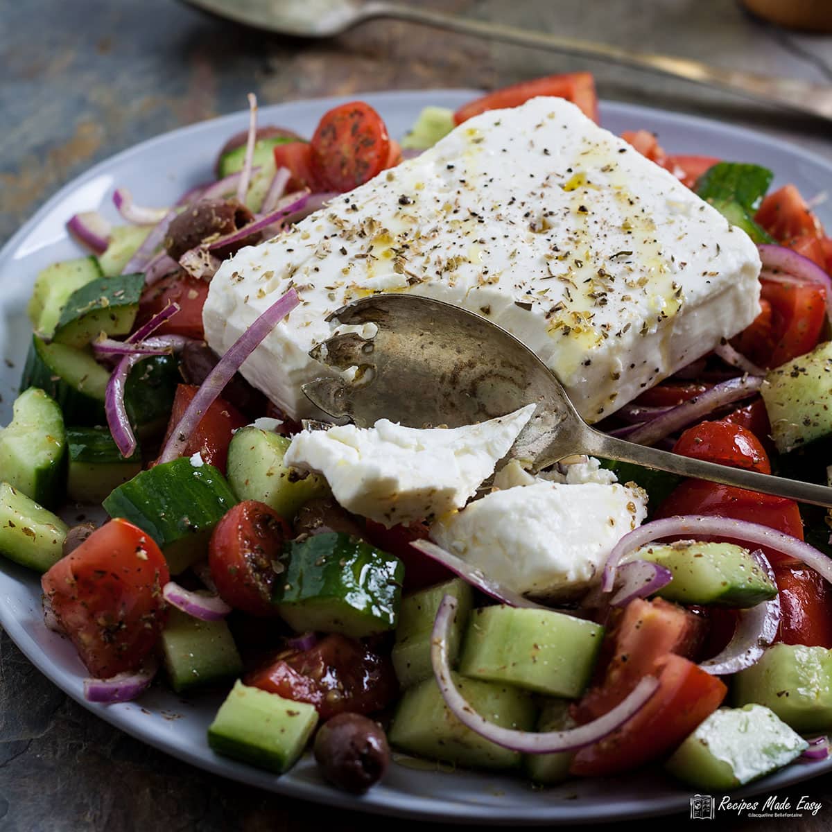 classic greek salad with broken block of feta.