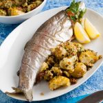 plate of oven baked trout with crushed new potatoes